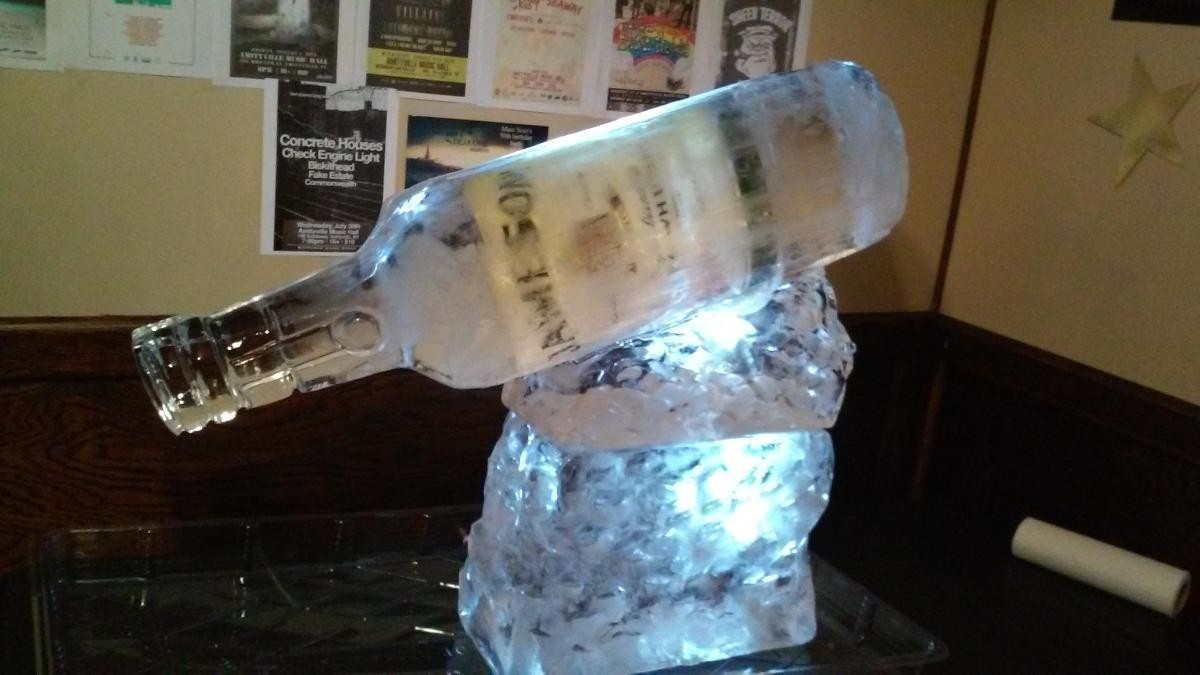 Martini glass ice bar with bottle holders and ice luge